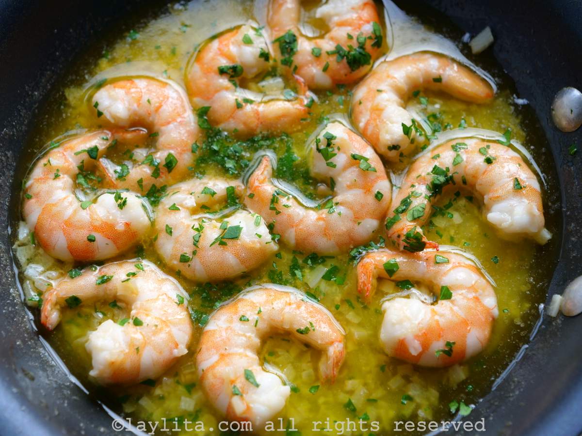 Closeup shot of gambas al ajillo after cooking in a black skillet