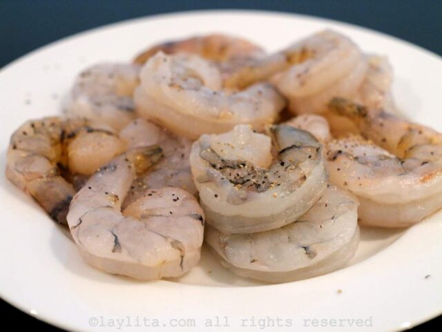 Season the raw shrimp with salt and pepper