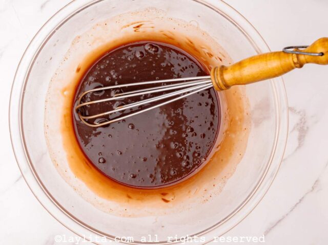 Chocolate ganache sauce in a glass bowl