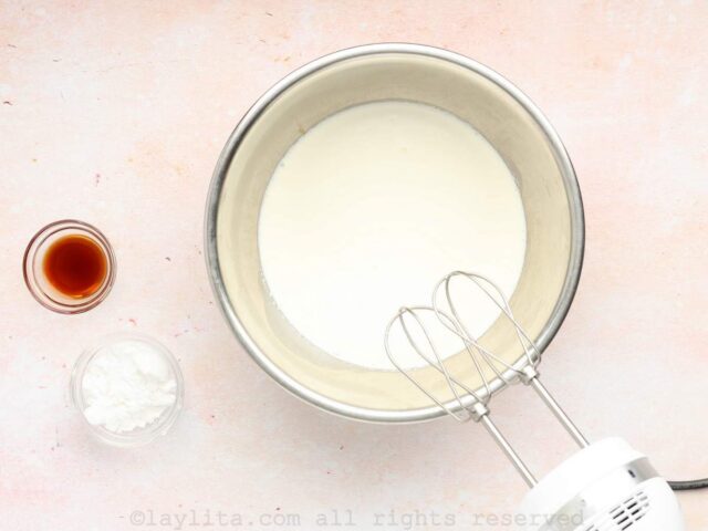 Cold heavy cream in a mixing bowl