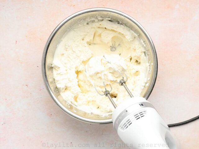 Whipped cream in a bowl with a mixer in it