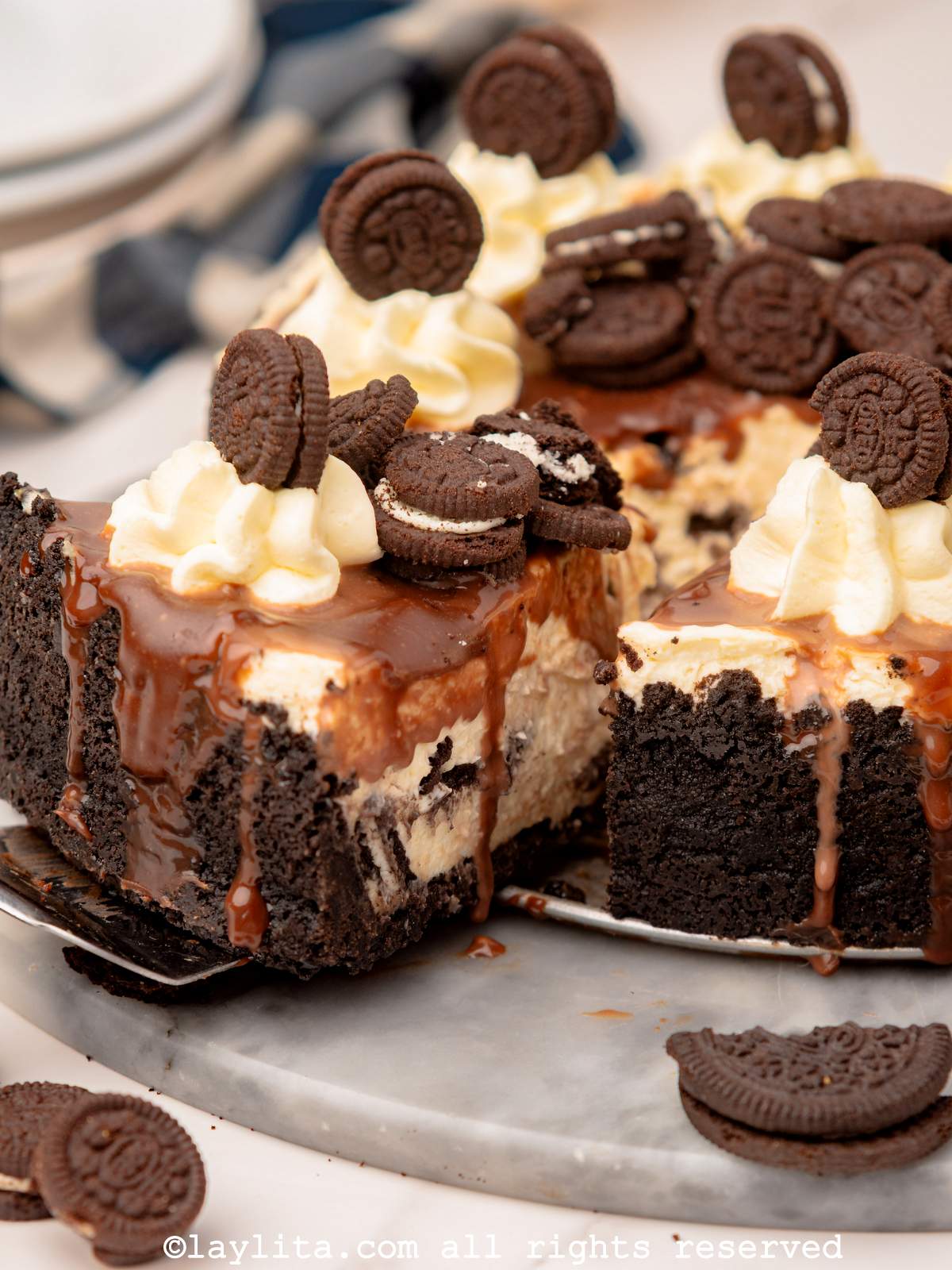 An Oreo Cheesecake with a slice being removed from it