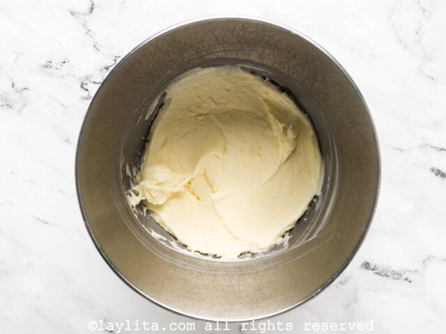 A mixing bowl full of cream cheese frosting using full fat block cream cheese