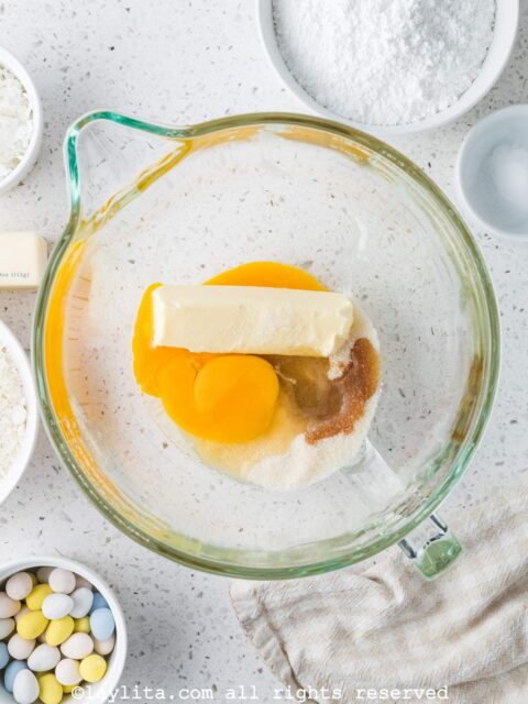 A mixing bowl with butter, eggs, sugar