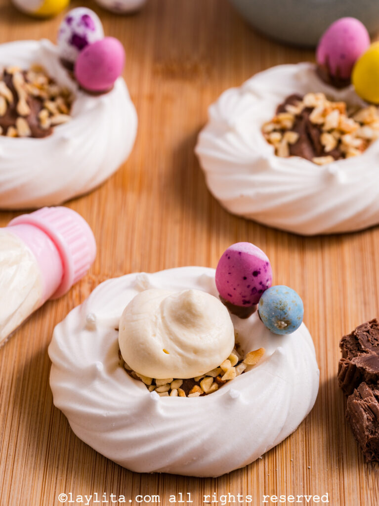 A meringue nest with chocolate, hazelnuts and lemon custard cream, with more in the background
