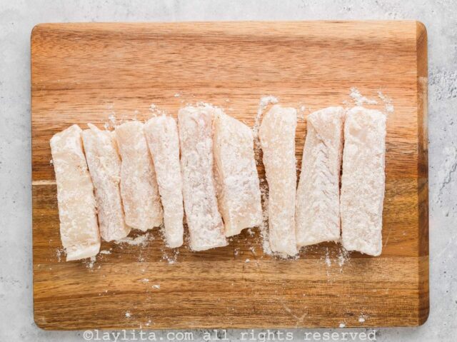 Dip each strip of fish in the seasoned flour mix