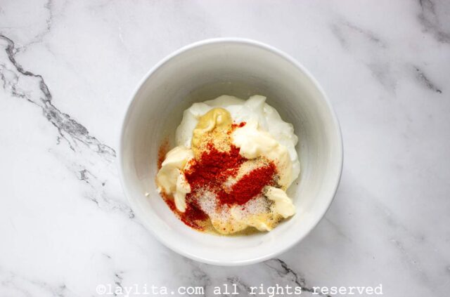 Ingredients for a yogurt dressing in a small bowl