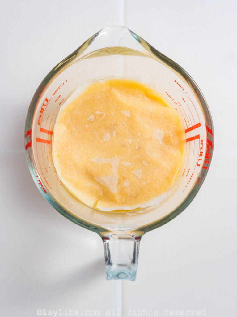 Lemon custard covered with baking paper in a glass container