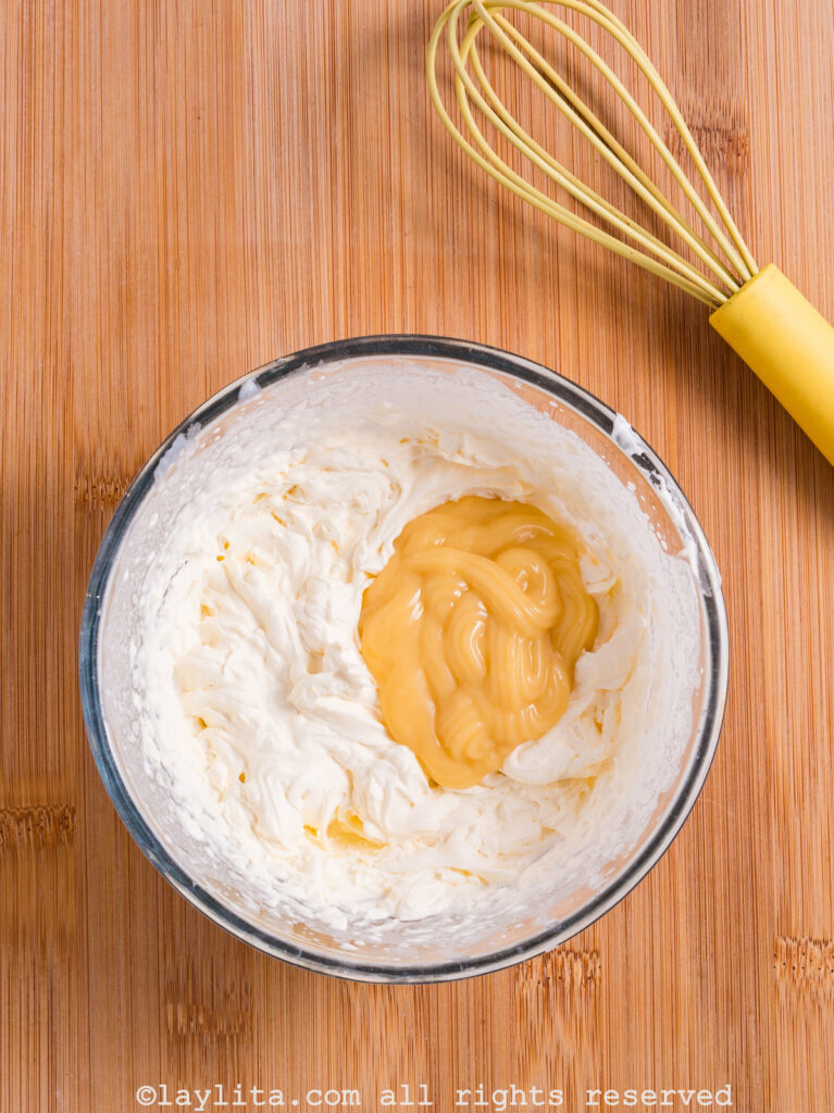 Whipped cream and lemon custard being mixed together