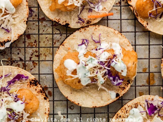 Fish tacos being assembled on a wire rack