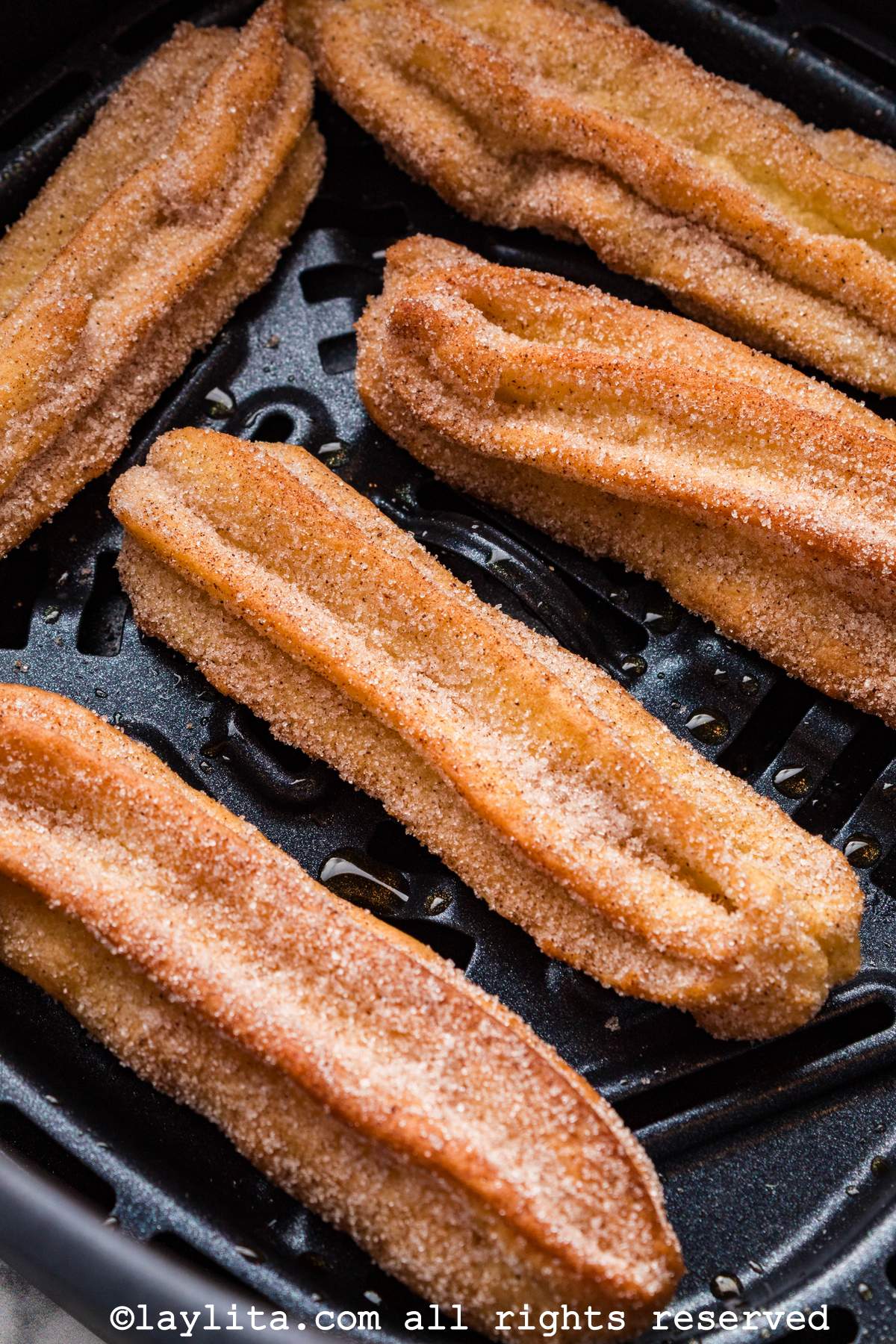 Close up shote of several churros in the air fryer
