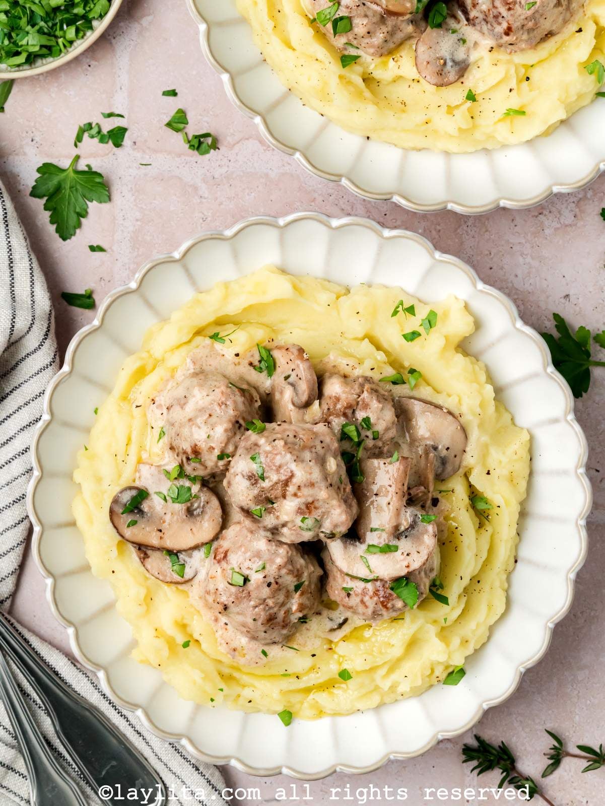Overhead view of beef stroganoff meatballs served on mashed potatoes