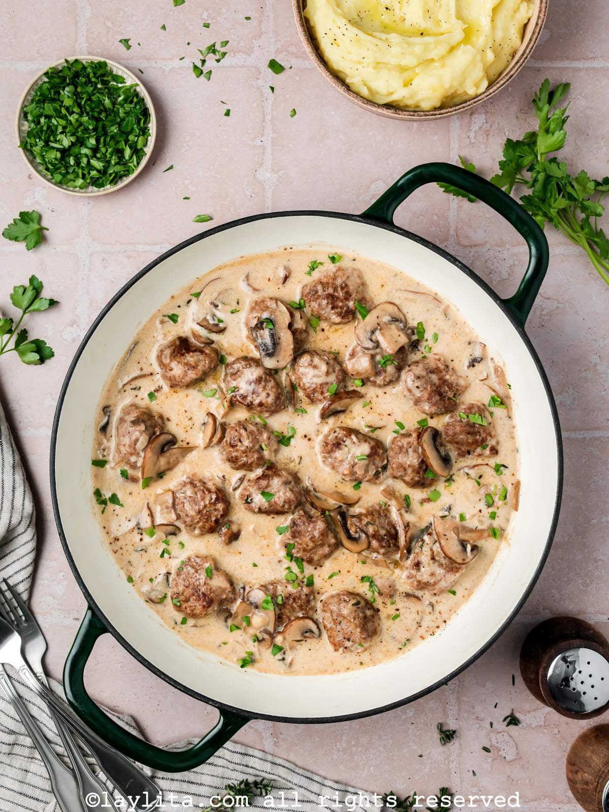Overhead shot of beef stroganoff meatballs in a skillet after cooking.