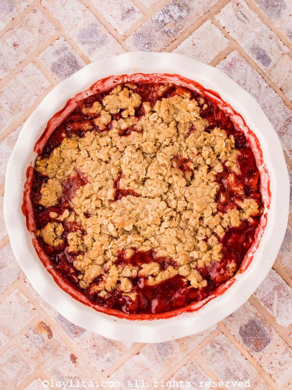 Overhead shot of a pie dish full of strawberry crisp