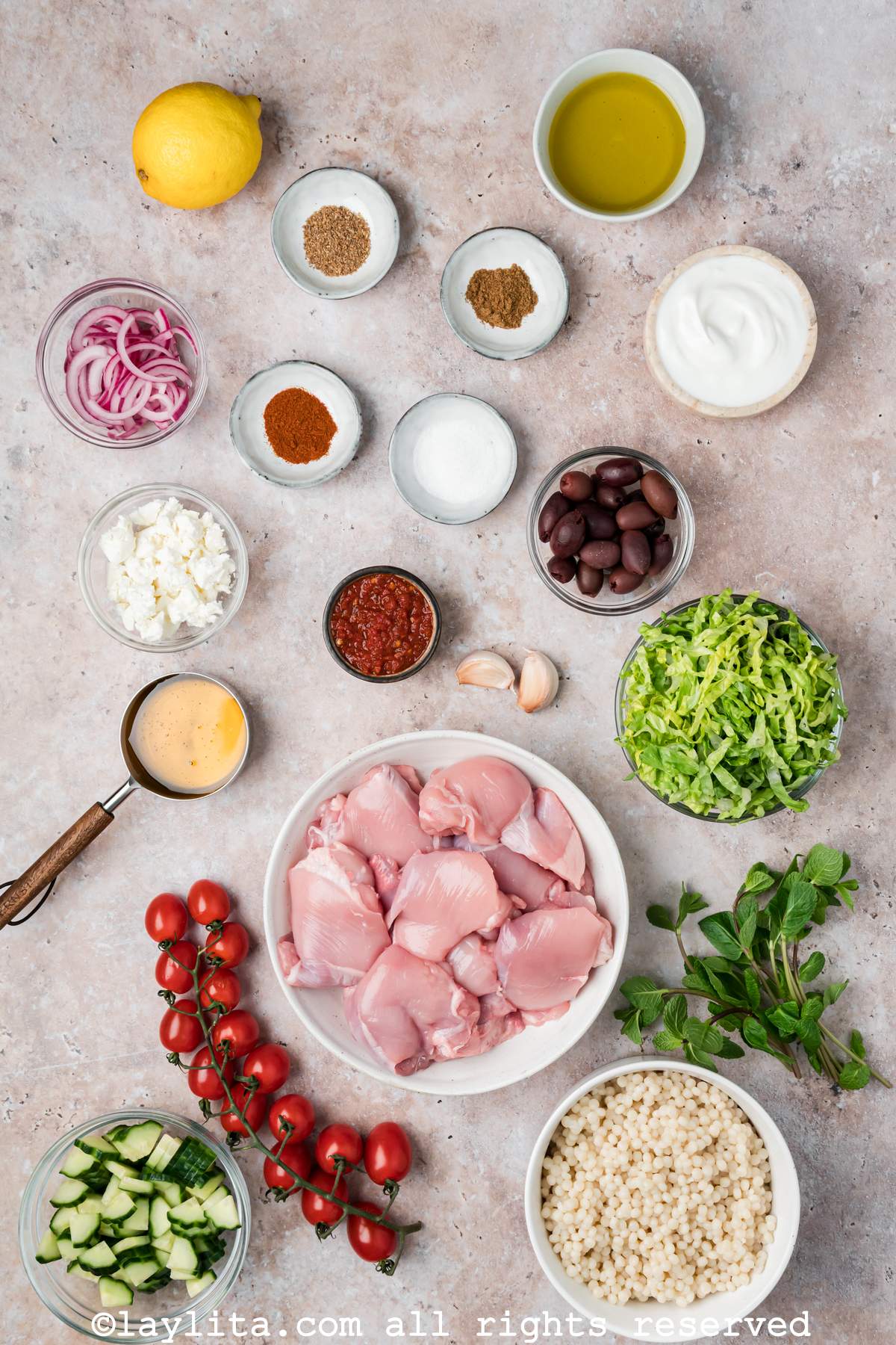 Ingredients needed to make harissa chicken bowls on a kitchen counter.