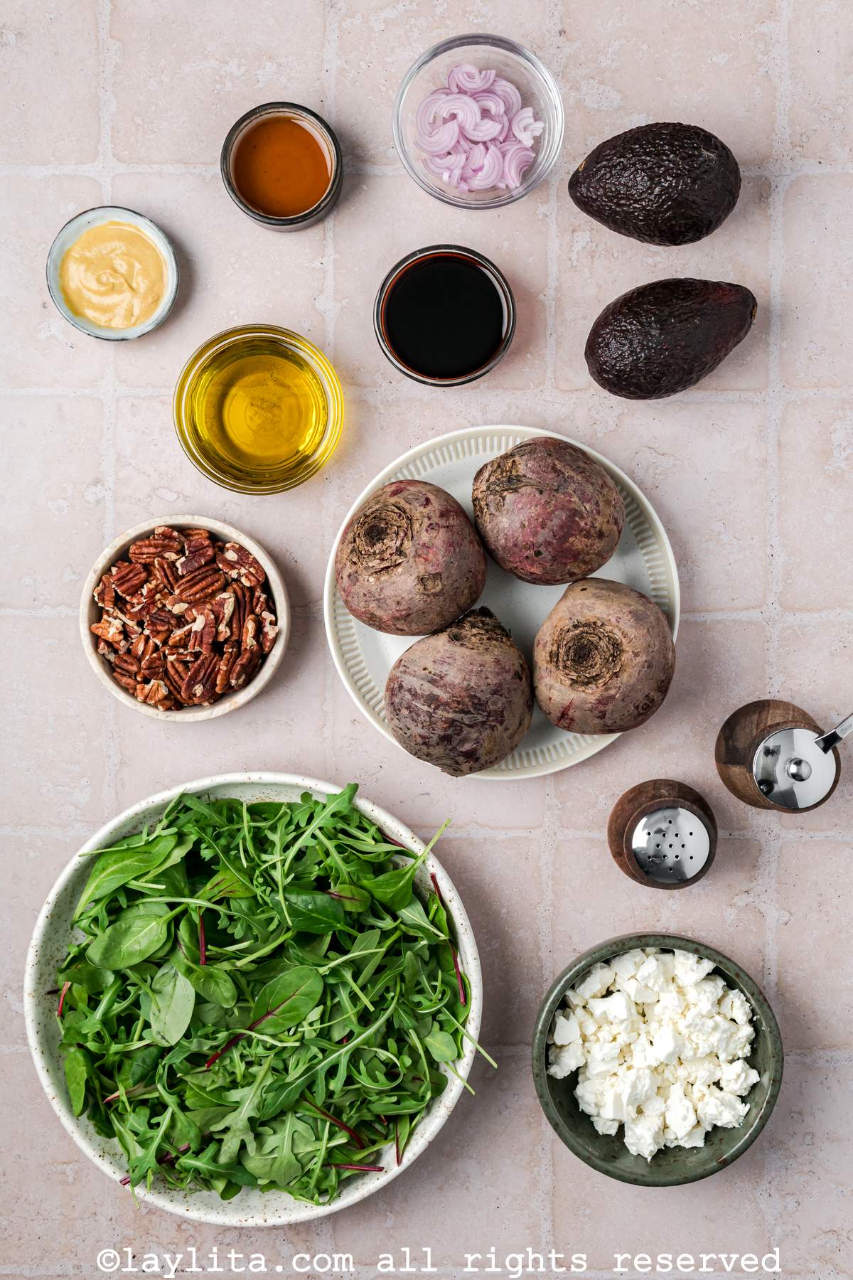 Ingredients for Roasted Beet Salad with Feta Cheese, Avocado, shallots, pecans and balsamic vinaigrette on a tiled kitchen counter
