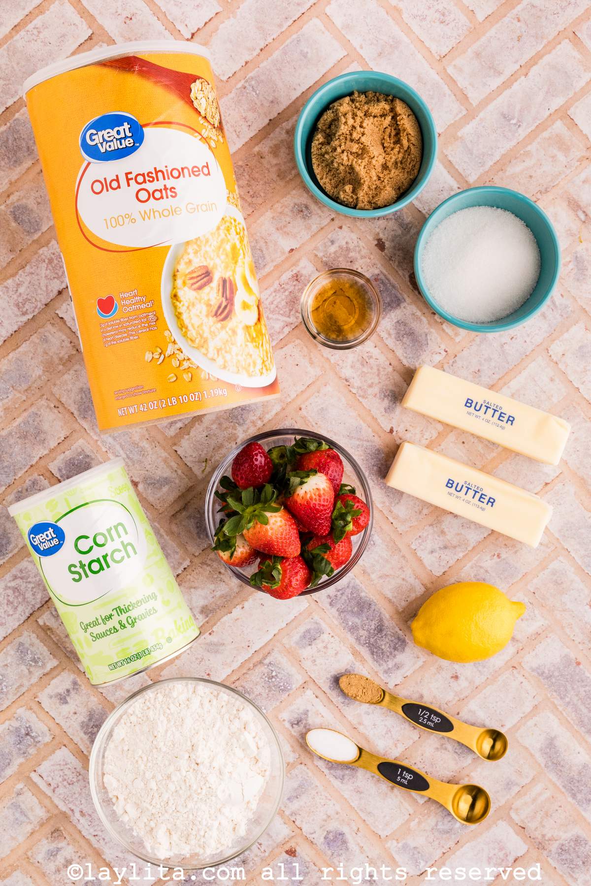 Overhead shot of the ingredients needed to make Strawberry Crisp on a tile countertop