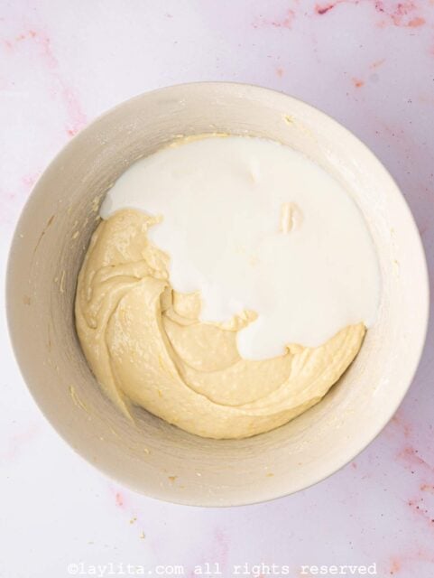 Buttermilk being added to a cupcake batter