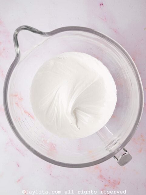 Glossy meringue in a glass mixing bowl