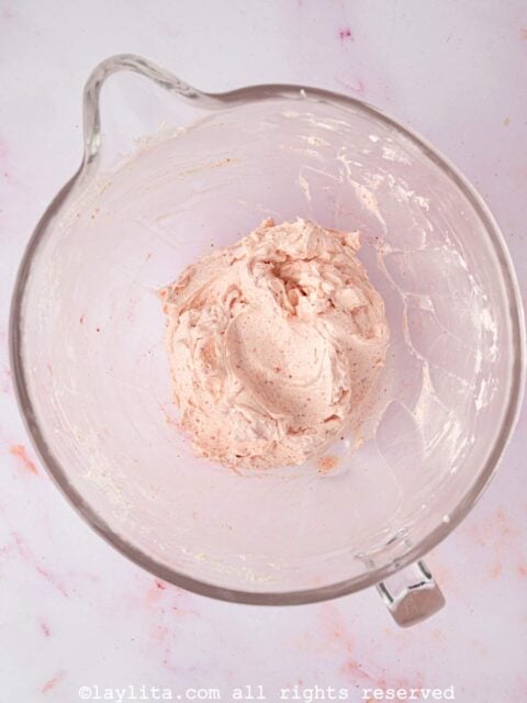 A mixing bowl with strawberry Swiss meringue buttercream