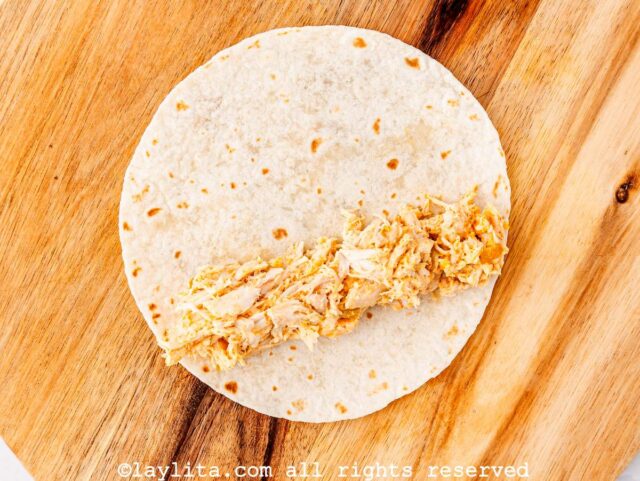 Chicken and cheese mix on a flour tortilla