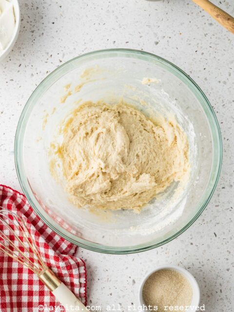 Shortcake biscuit dough being prepared in a glass bowl on a kitchen counter