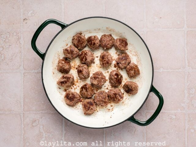 Meatballs browning in a skillet