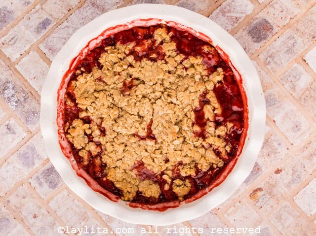 Strawberry crisp in a white pie dish after baking