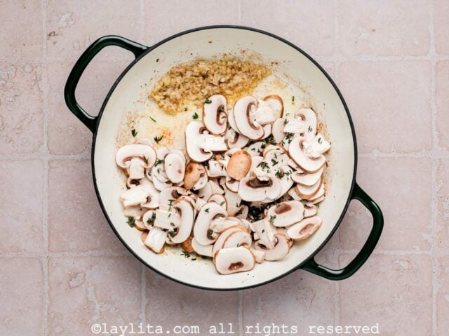 Mushroom slices being added to a skillet