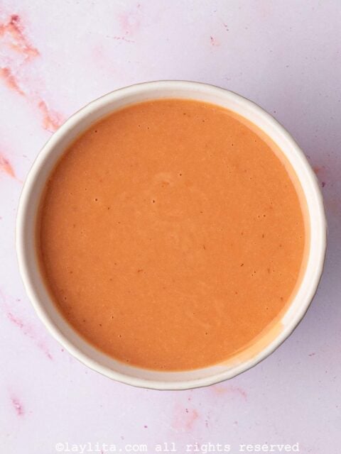 A white bowl full of homemade strawberry lemon curd