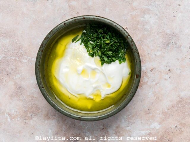 Yogurt, lemon, olive oil, mint in a small bowl