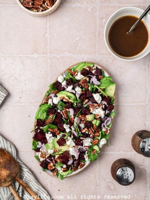 Preparation for beet salad with feta, avocado, pecans with the dressing on the side