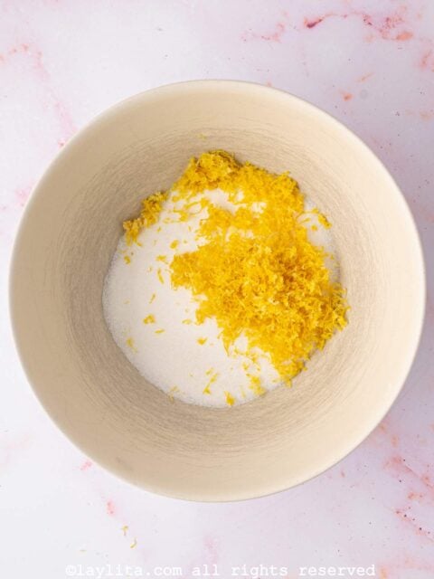 Sugar and lemon zest in a mixing bowl