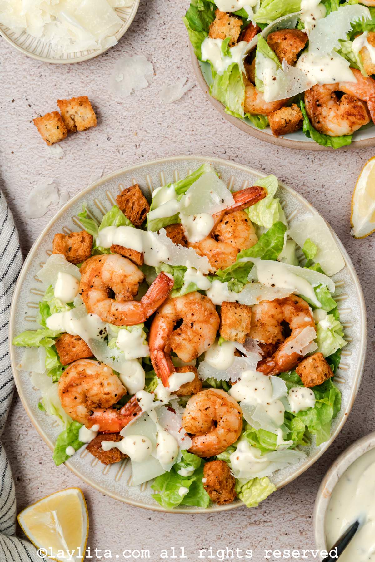 Overhead shot of a bowl served with shrimp Caesar salad.
