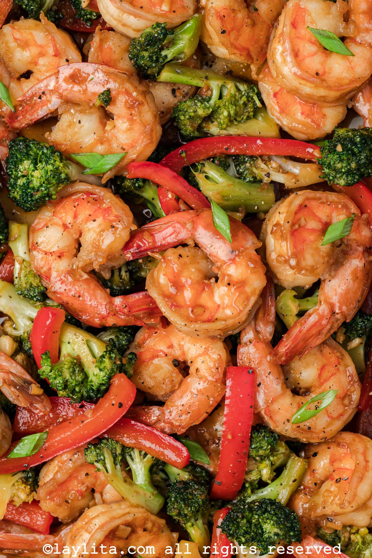 Close up of shrimp broccoli stir fry with red peppers. 