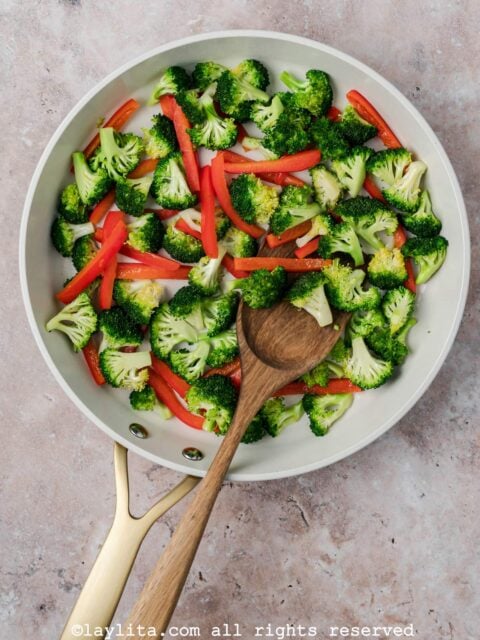 Broccoli and red bell pepper strips in a skillet
