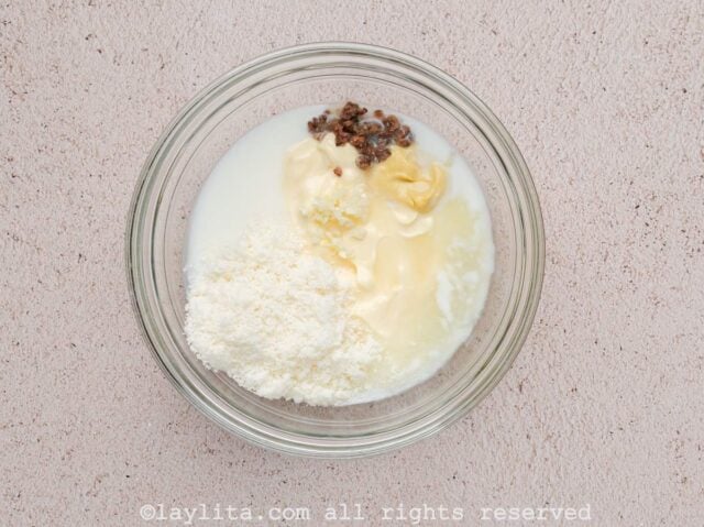 Ingredients for Caesar dressing in a glass bowl