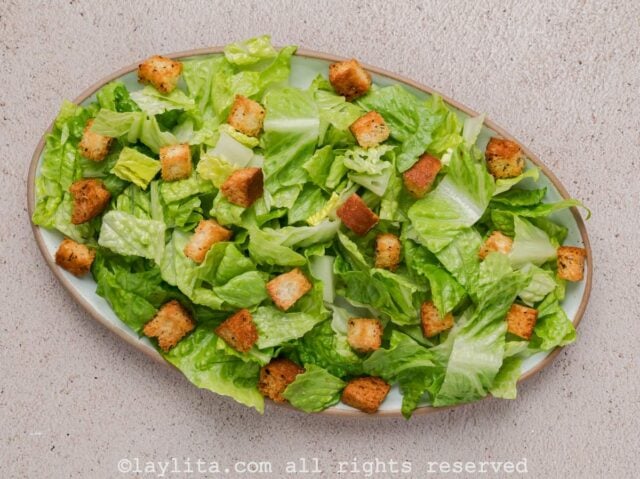 Chopped romaine lettuce and croutons on a salad platter