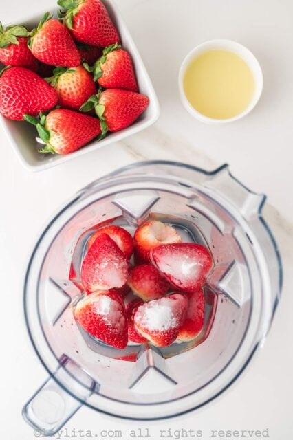 Strawberries and sugar in a blender