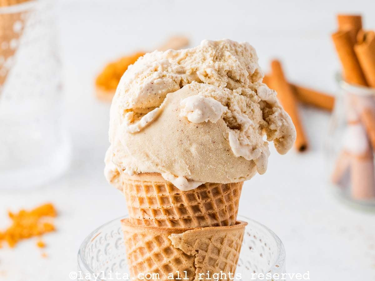 Side view of a scoop of cinnamon ice cream on a cone.