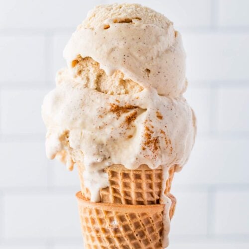 Side view of a scoop of cinnamon ice cream on a cone.