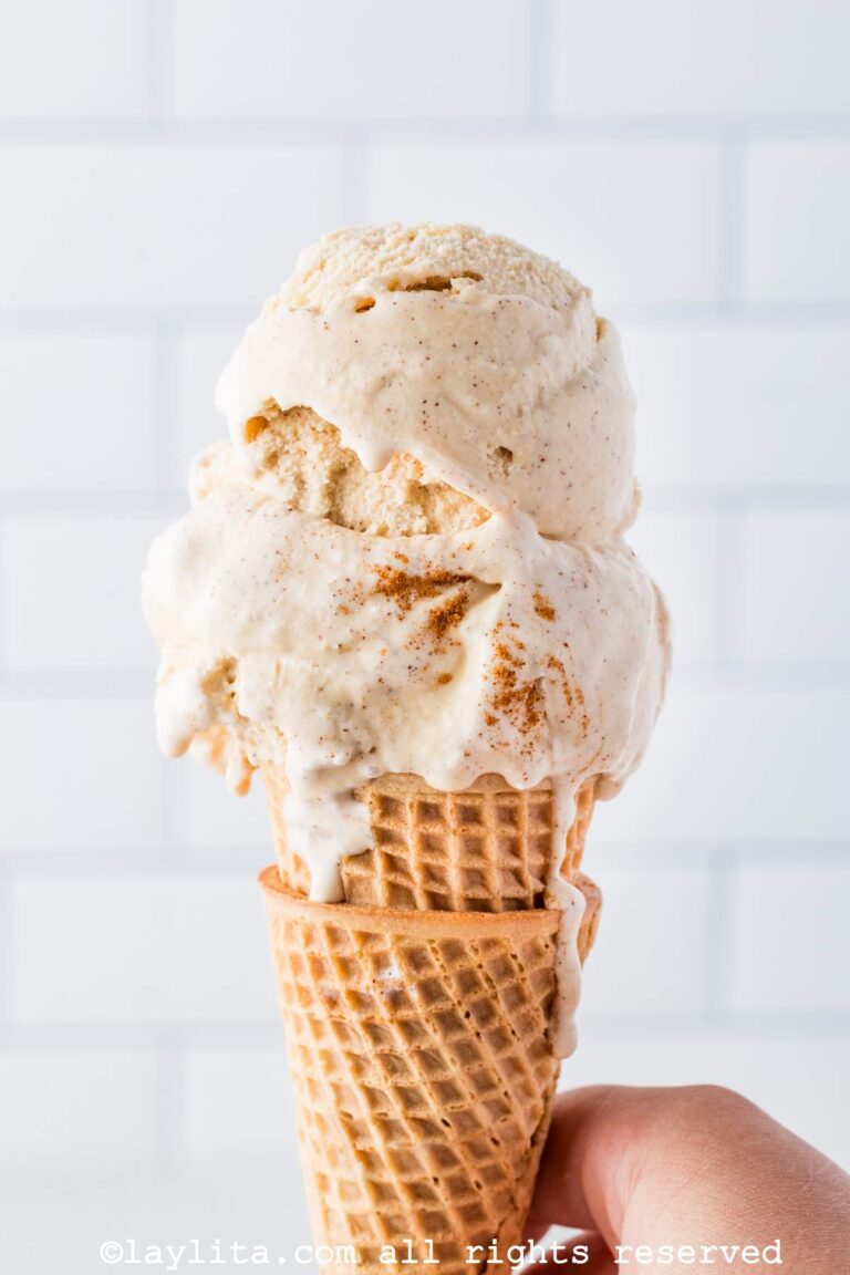 Side view of a scoop of cinnamon ice cream on a cone.