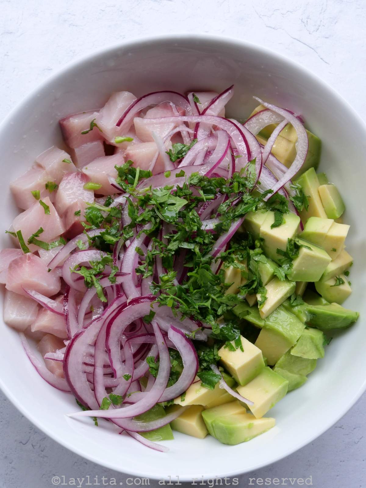 A white bowl with the ingredients for hamachi ceviche before being mixed together