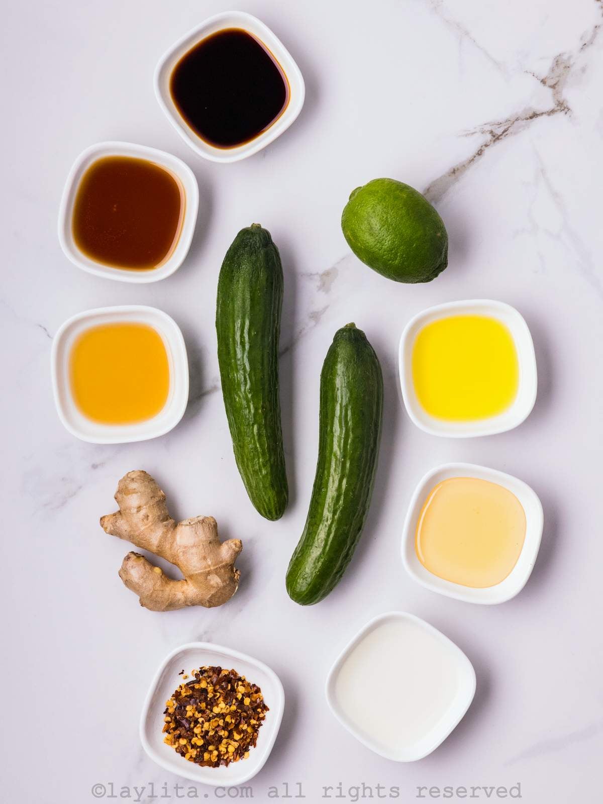 Ingredients for Asian Cucumber Salad with ginger lime dressing on a white countertop