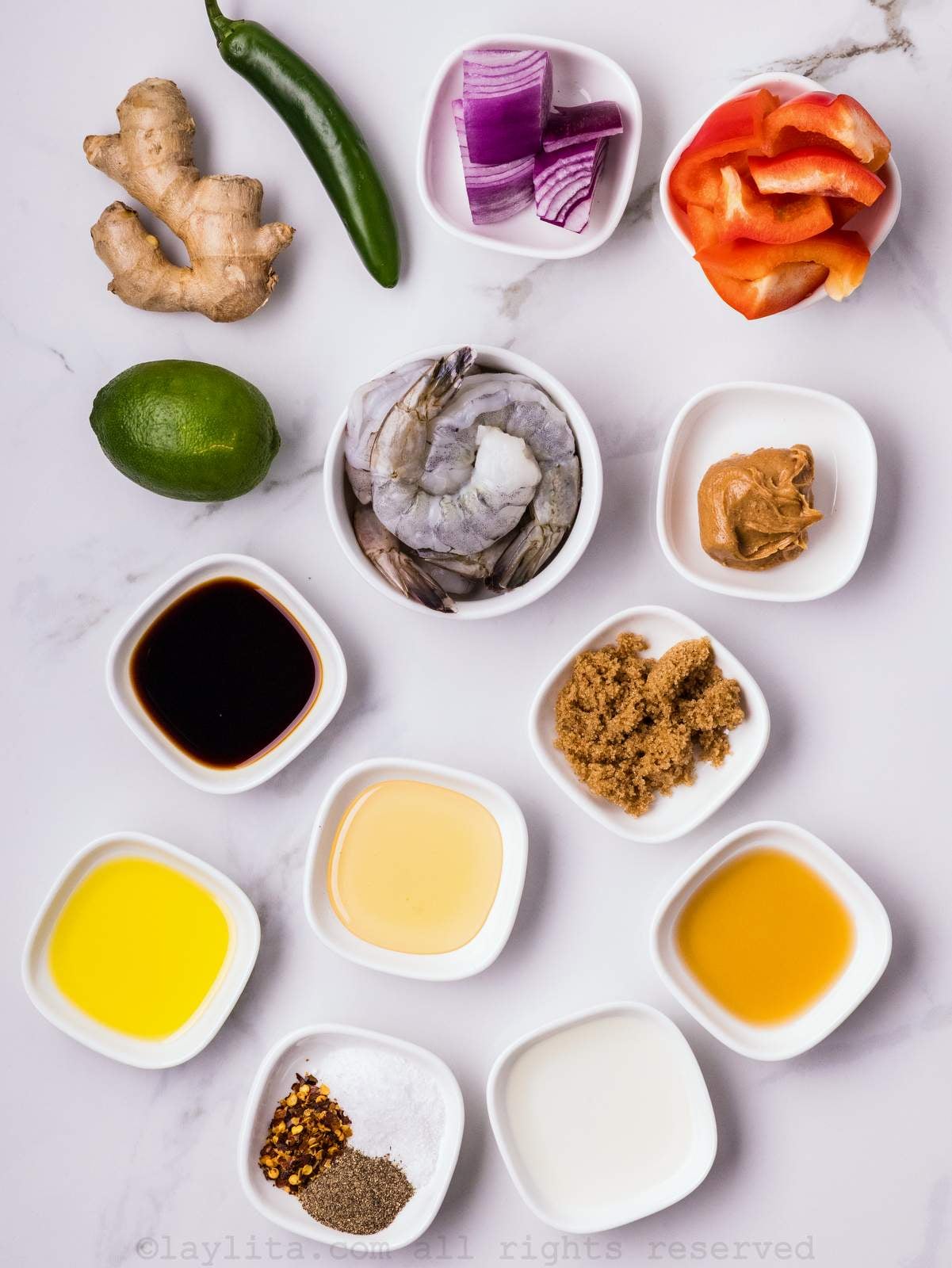 Ingredients for Asian grilled shrimp skewers with peanut sauce on a kitchen counter