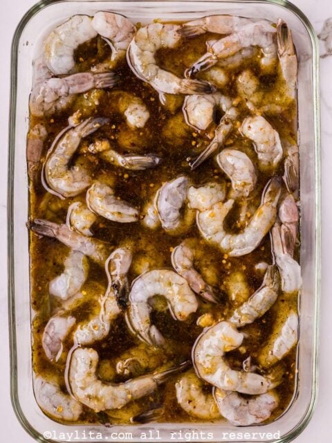 Shrimp marinating in a glass container