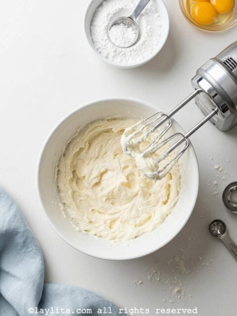 Creaming butter in a white bowl with a mixer