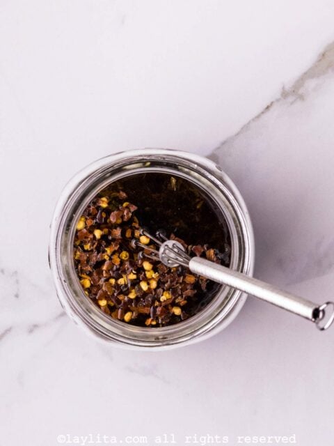 A dressing being mixed in a jar