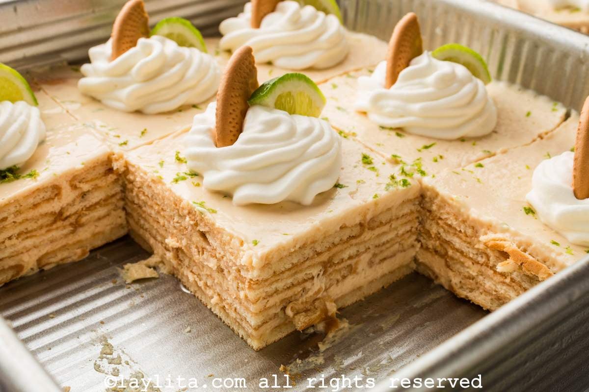 Side view of carlota de limón in a baking dish with some slices missing to show the layers.