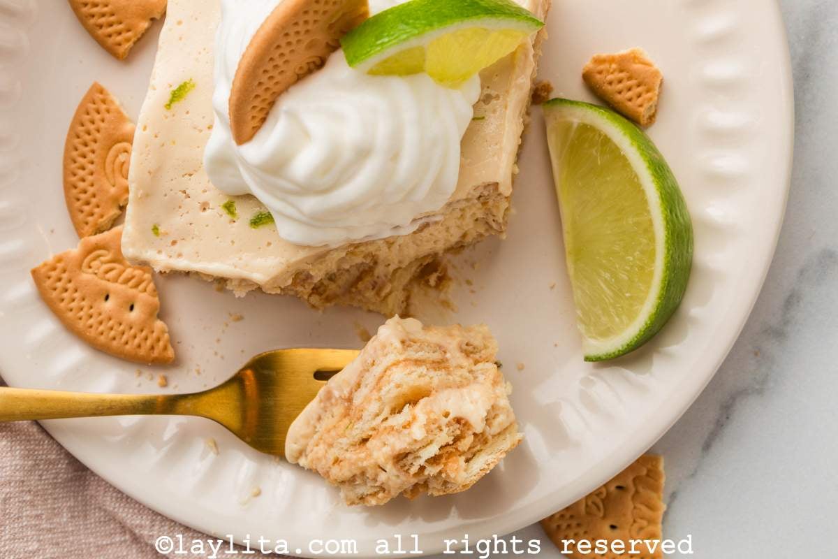 Overhead view of a slice of Mexican Carlota de Limon with a fork taking a bite out